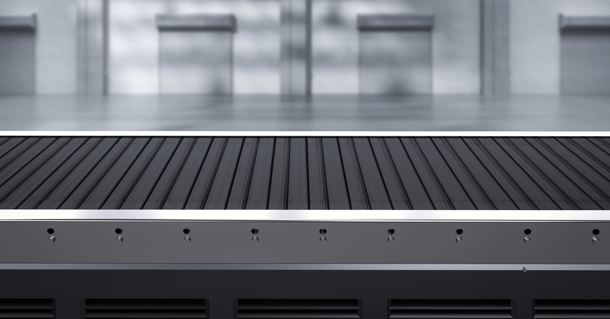 An industrial conveyor belt system in a factory, transporting items through various stages of production.