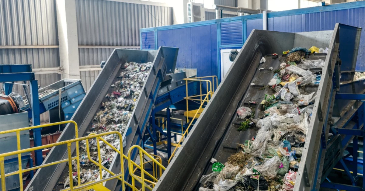 RedlineSystemsInc-449001-Incline-Conveyors-Waste-Image1 Two incline conveyors move garbage upward in a waste sorting and recycling plant. Both feature belts with cleats.